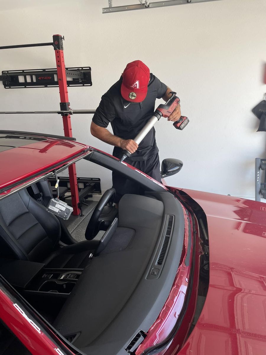Jay applying urethane for a new windshield install